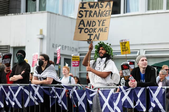 A counter-protester makes a point outside the Cladhan Hotel in Falkirk, the scene of demonstrations by anti-refugee groups (Picture: Jeff J Mitchell)