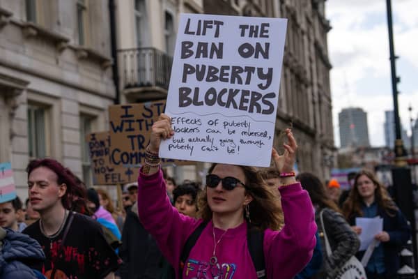 Trans rights activists take part in a protest against the ban on puberty blockers in April 2024 in London