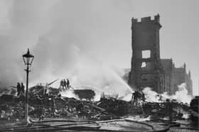 Firefighters damp down ruined buildings in Duff Street, Edinburgh, after German bombers caused a massive fire in 1940
