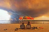 People watch as a major wildfire rages on the other side of Lake Lacanau in south-west France, on July 24 (Picture: Maximilien Lamy)