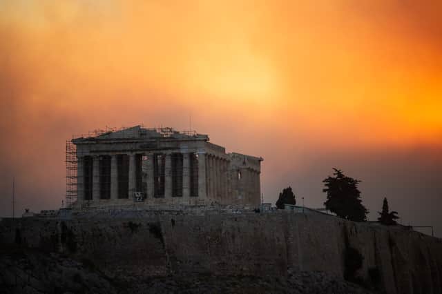 The Parthenon temple in Athens is clouded in smoke from a wildfire on the surrounding hills in 2024 (Picture: Angelos Tzortzinis)