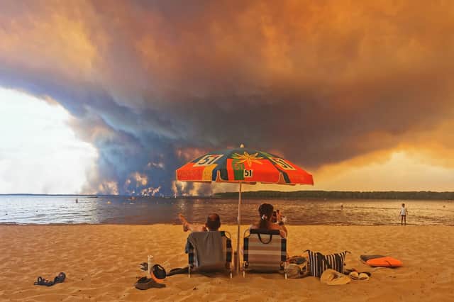 People watch as a major wildfire rages on the other side of Lake Lacanau in south-west France, on July 24 (Picture: Maximilien Lamy)