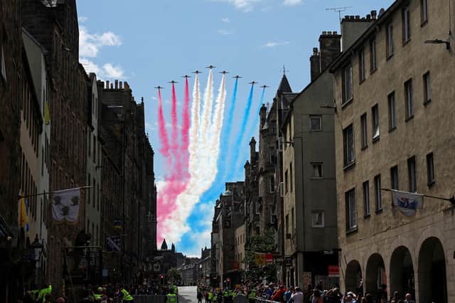 The British Royal Air Force's (RAF) aerobatic team, the "Red Arrows", perform a fly-past over The Royal Mile in Edinburgh on 5 July 2023.