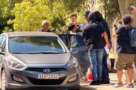 The suspect, widely reported to be Sharif Ahmadzai (centre), being led out of the Athens Court House complex in Kypseli, Athens, where he appeared accused of killing 38-year-old Elisabeth-Jane Ross and disposing of her body in a suitcase.   