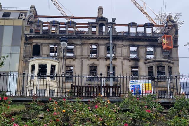 Workmen inspect the facade of the former Debenhams store in Princes Street four weeks after fire gutted part of the building