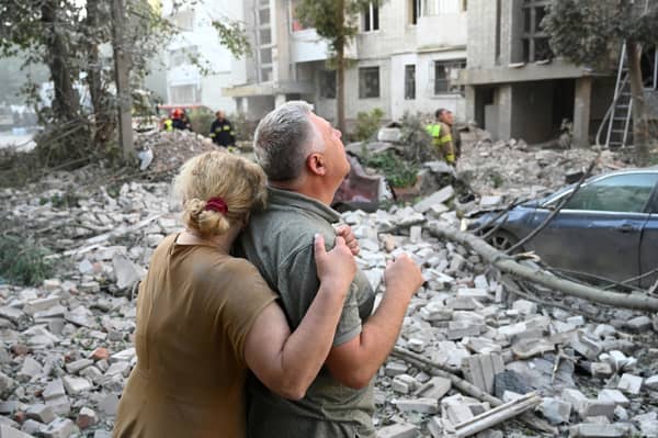 Two survivors of a Russian missile strike that partially destroyed a residential building in Lviv, Ukraine, on July 30 survey the damage (Picture: Yuriy Dyachyshyn)