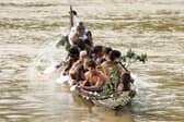 Maori paddle a canoe on the Whanganui River, which has been given legal rights and can now sue its polluters (Picture: Hagen Hopkins)