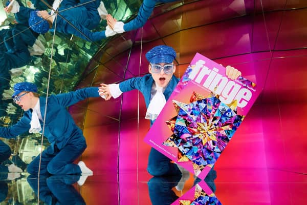 A performer holds an Edinburgh Fringe festival programme