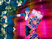 A performer holds an Edinburgh Fringe festival programme