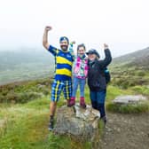 Paul Choat with his daughter Skye and Nicola Roseman CEO of My Name5 Doddie Foundation on Schiehallion