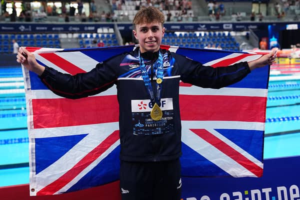 Britain's Filip Nowacki holds his national flag while posing with his gold medal after the podium ceremony of the men's 200m breaststroke yesterday.