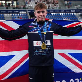 Britain's Filip Nowacki holds his national flag while posing with his gold medal after the podium ceremony of the men's 200m breaststroke yesterday.