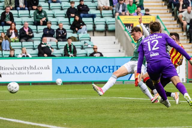 Owen Elding slides home Hibs' winner against Partick Thistle.