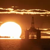 A sunset behind an oil rig
