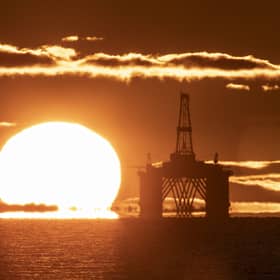 A sunset behind an oil rig
