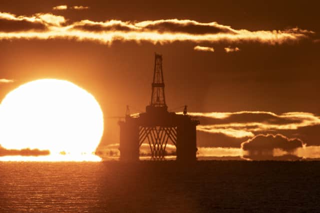A sunset behind an oil rig
