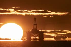 A sunset behind an oil rig