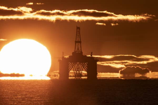 A sunset behind an oil rig