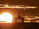 A sunset behind an oil rig