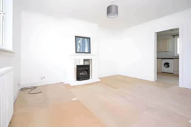 A bright living room provides a welcoming centrepiece, with a fireplace creating a focal point