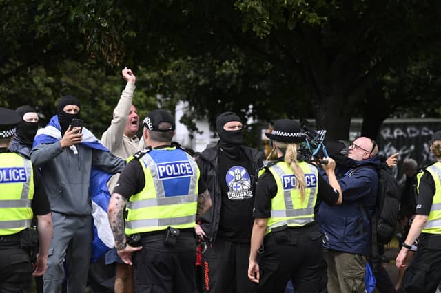 Protesters run from police during an anti-immigration protest in Glasgow in July. Picture: PA