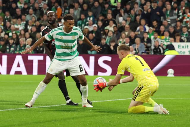 Celtic defender Auston Trusty shields the ball from LASK striker Samuel Adeniran as goalkeeper Viljami Sinisalo comes out to collect