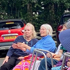A care home resident enjoys a performance.