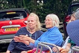 A care home resident enjoys a performance.