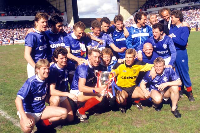 The Rangers team, captained by Terry Butcher, celebrate with the Scottish Premier League trophy in May 1987