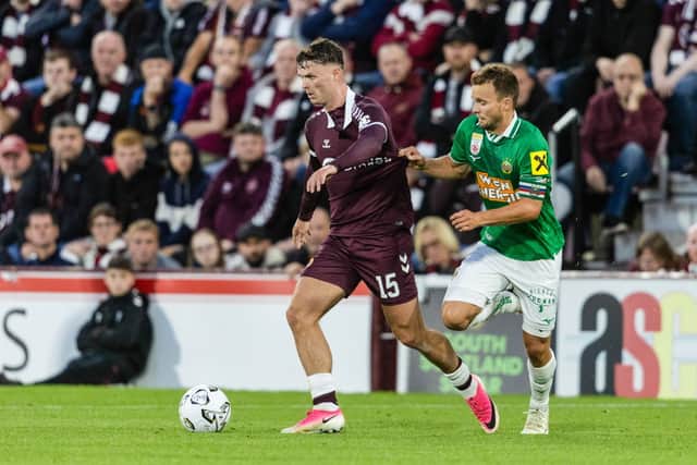 Hearts' Josh McPake (L) and Rapid Vienna's Matthias Seidl (R) in action