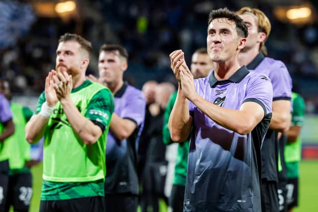 Jamie McGrath and the Hibs players applaud the fans after their goalless draw in Ghent. (Photo by Rico Brouwer / SNS Group)
