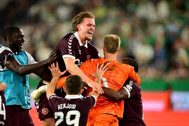 Hearts players celebrate with goalkeeper Beau Reus after the penalty shootout win over Rapid Vienna at the Allianz Stadion.  (Photo by Christian Bruna/Getty Images)