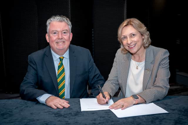 Royal Aberdeen Golf Club captain Laurence McLeod and Carron Taylor, the captain of Aberdeen Ladies Golf Club, sign the historic transfer agreement to unite the clubs