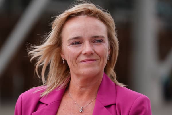 Headshot of Sandie Peggie smiling, wearing a pink blazer