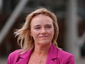 Headshot of Sandie Peggie smiling, wearing a pink blazer