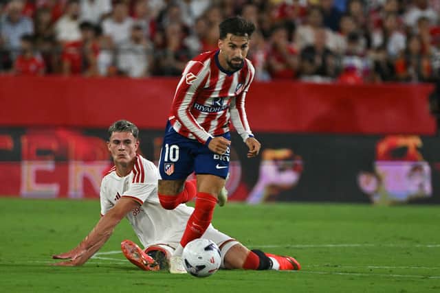 Robbie Ure tussles with Atletico Madrid's Alex Baena during the 3-1 defeat in La Liga on Saturday night.