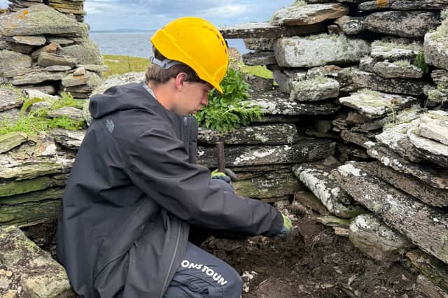 A Gordonstoun student undertaking excavation work