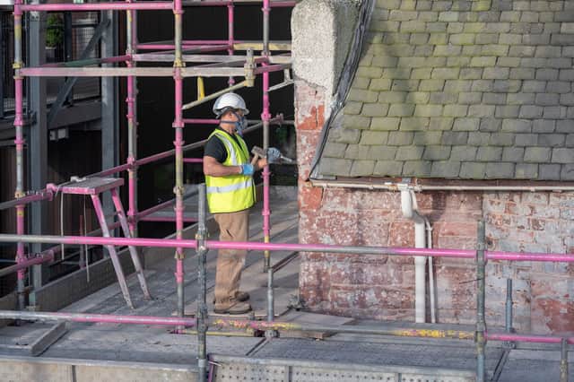 The external roughcast being removed to allow the stonework to dry out