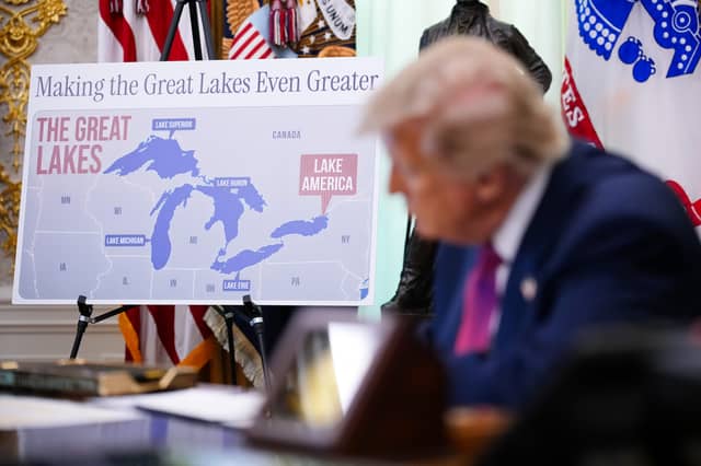 Donald Trump signs an executive order in the White House declaring Lake Ontario is to be known as 'Lake America' (Picture: Andrew Harnik)