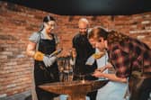 Blacksmith Joe Shevelan, right, showcases his skills at the new forge in Gretna Green. Picture: Mathias Newberry/PA Wire