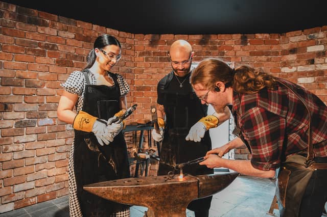 Blacksmith Joe Shevelan, right, showcases his skills at the new forge in Gretna Green. Picture: Mathias Newberry/PA Wire