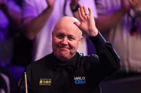 Scotland's John Higgins safely made it through to the second round in Cheltenham yesterday.