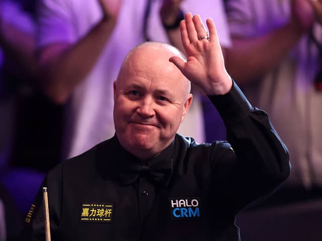 Scotland's John Higgins safely made it through to the second round in Cheltenham yesterday.