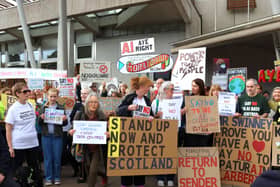 Protesters against data centres holding banners and placards, outside the Scottish Parliament