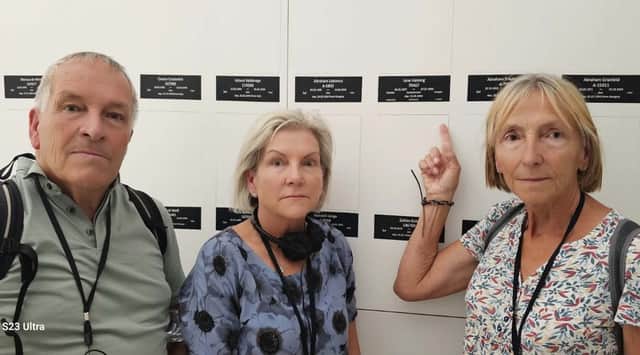 Relatives of Scottish missionary Jane Haining, Kevin O'Brien, Liz Harrigan and Patricia Audis, in front of a section of the Auschwitz Birkenau Memorial and Museum's main exhibition where the name of Miss Haining who was murdered by the Nazis after caring for Jewish schoolgirls in Budapest has been added