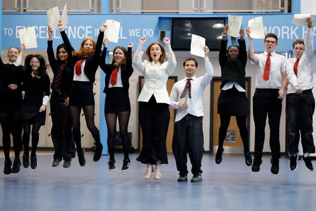 Education Secretary Mairi McAllan, centre, celebrates with students as they receive their exam results at Broughton High School (Picture: Jeff J Mitchell)