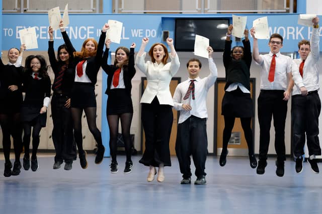 Education Secretary Mairi McAllan, centre, celebrates with students as they receive their exam results at Broughton High School (Picture: Jeff J Mitchell)