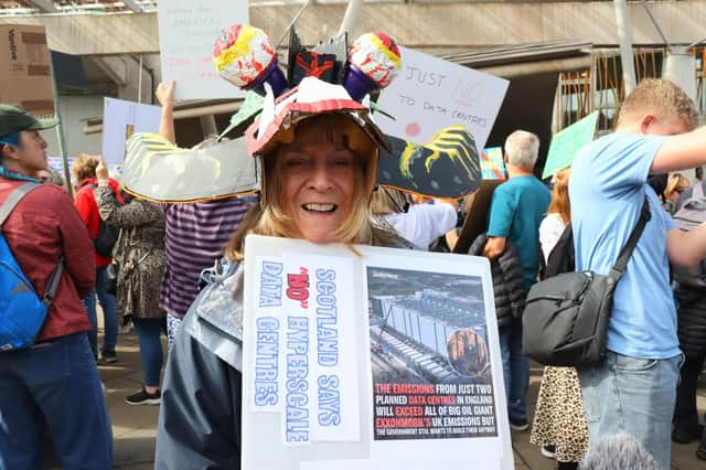 Jane Wooley, from Edinburgh joins campaigners and community members from across Scotland taking part in a protest outside the Scottish Parliament
