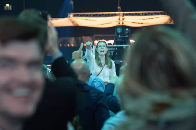 A demonstrator shouts whilst Reform UK leader Nigel Farage delivers a keynote speech during the Reform UK National Conference, at the National Exhibition Centre in Birmingham