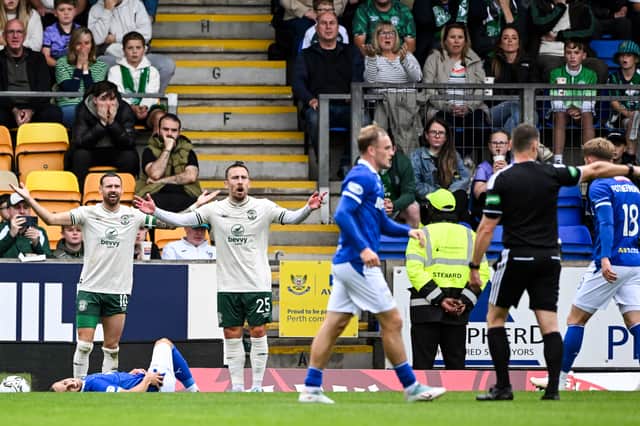 Referee Steven McLean (R) awards a penalty after Hibs' Martin Boyle fouls St. Johnstone's Enes Alic. (Photo by Paul Devlin / SNS Group)